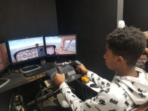Aviation camp student completing flight simulation lesson.